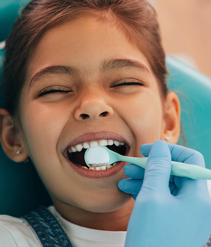 child getting teeth examined